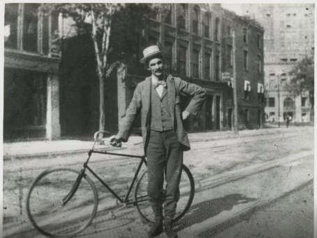 Black and white photo of Henry Ford with a bicycle